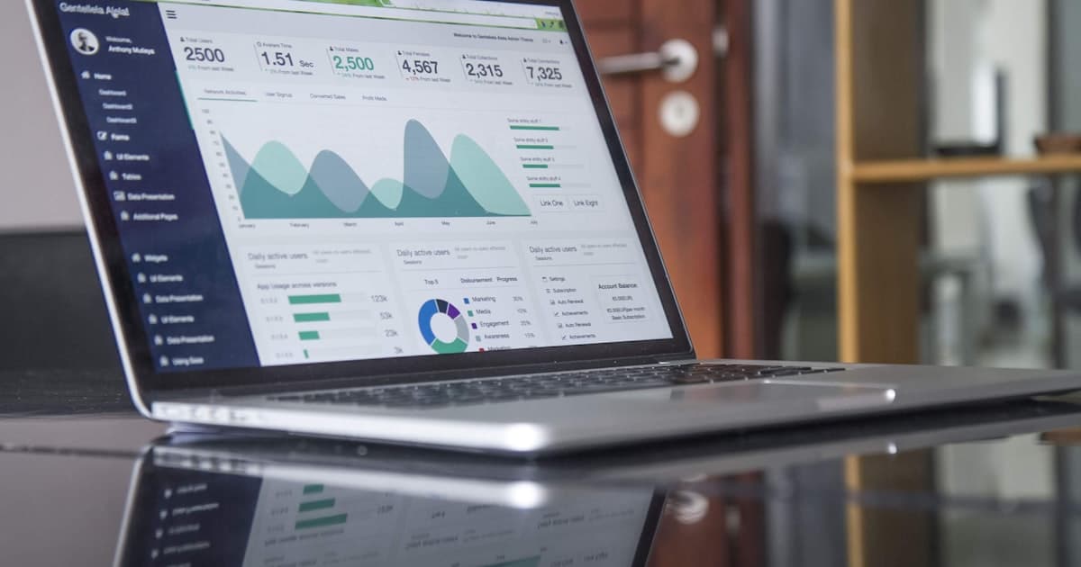 A laptop showing a website analytics dashboard with a falling traffic line.