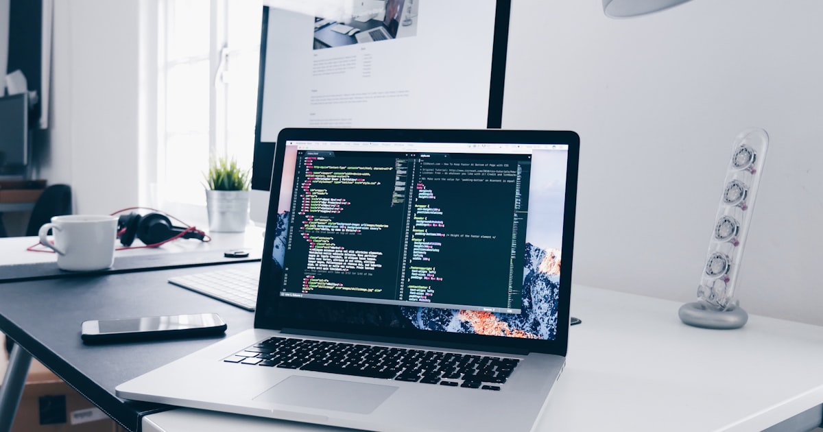 A UK SaaS developer and marketer reviewing SEO strategy on a coding workstation.